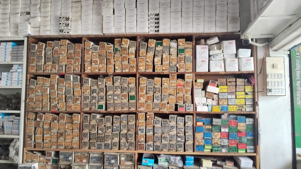Shelves of hand-labelled sewing machine parts at Babji Enterprises